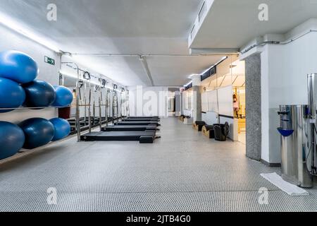 Gym wood interior with black yoga mat, small windows, no people. Copy space  Stock Photo - Alamy