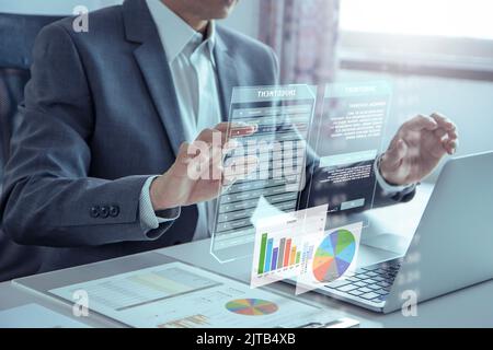Businessman or analyst touching futuristic virtual touchscreen for investing risk analysis and business performance Stock Photo