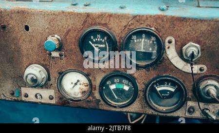 The rusty steel dashboard of a very old tractor close-up Stock Photo