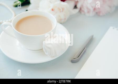 Modern home office concept. Computer, coffee and flowers. Stock Photo