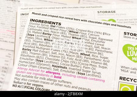 Close shot of packet of ASDA chocolate & nut cereal bar ingredients / list of contents. For food nutrition labeling, allergy advice warning. Stock Photo