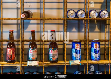 Beers from the Davo brewery in Deventer, one of nine historic Hanseatic towns on the IJssel river, province of Overijssel, Netherlands, stand on the shelf of the Davo Shop: the "Indie IPA" and two bottles of "Buiten Post", a collaboration brew with the Gulpener brewery, alongside cans of the white IPA "Migaloo" featuring a whale motif. Stock Photo