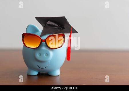 College graduate student diploma piggy bank. Stock Photo