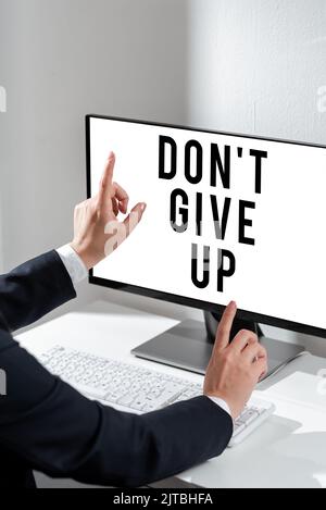 Writing displaying text Don T Give Up. Word for Keep trying until you succeed follow your dreams goals Team Members Looking At Whiteboard Stock Photo