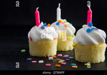 Delicious and Beautiful Mini Vanilla Muffins with Candles and Candies Horizontal Stock Photo