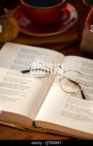 close up of open book of poems and glasses Stock Photo