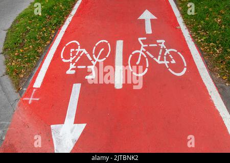 bike lane or red road with signs of bicycles Stock Photo