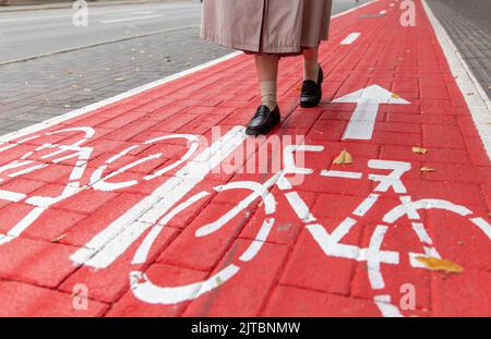 feet walking along bike lane or road for bicycles Stock Photo