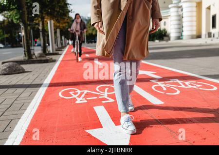 feet walking along bike lane or road for bicycles Stock Photo