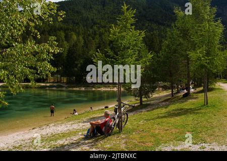 Kranjska Gora, Slovenia - August 21st 2022. A cyclist enjoys a break at Jasna Lake near Kranjska Gora in the Upper Carniola region of north Slovenia Stock Photo