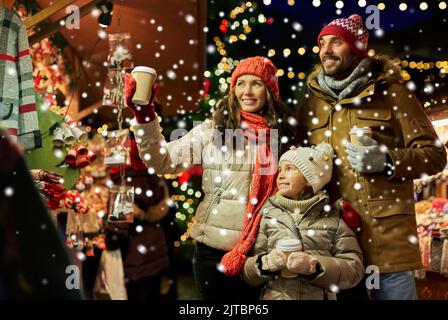 family with takeaway drinks at christmas market Stock Photo