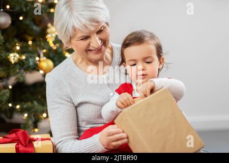 grandmother and baby girl with christmas gifts Stock Photo