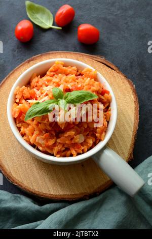 Kritharaki with tomatoes and chicken. Traditional type of Greek pasta shape of rice. Greek version of Italian Orzo Stock Photo