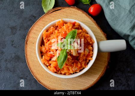 Kritharaki with tomatoes and chicken. Traditional type of Greek pasta shape of rice. Greek version of Italian Orzo Stock Photo