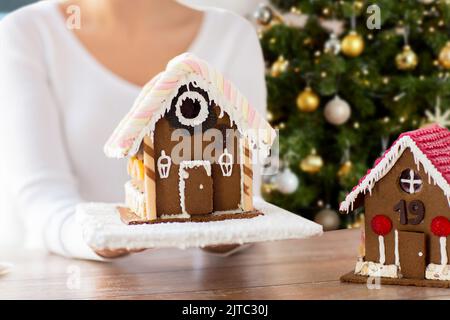 close up of woman with christmas gingerbread house Stock Photo