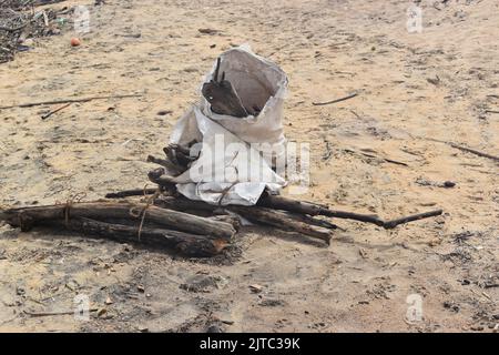 Garbage bags. People collecting Wood and plastic wastage which has washed ashore due to rough seas in the Indian ocean in the outskirts of Colombo. They use the wood as firewood for cooking and sell the plastic for recycling purposes. Sri Lanka. Stock Photo
