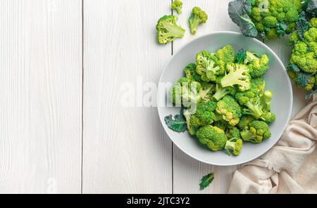 A plate of broccoli on a white wooden background. Stock Photo