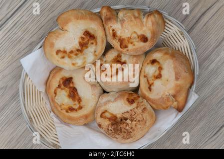 Overhead view of full basket of garlic and cheese rolls makes the perfect appetizer before an Italian food meal. Stock Photo
