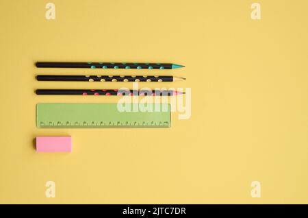 Pencils, ruler and rubber on yellow background, flatlay. Back to school Stock Photo