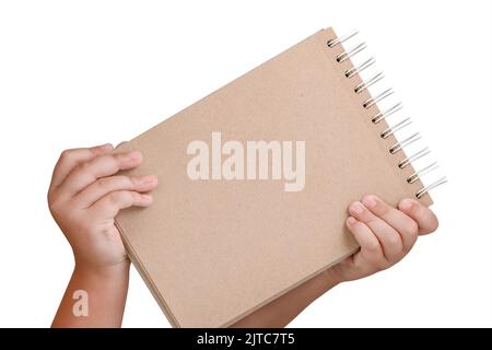 Notepad isolated on white background. Brown notepad made from recycled paper on a white background in the hands of a child Stock Photo