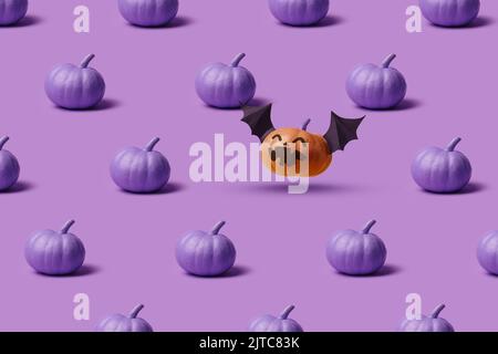 Pattern, Halloween pumpkins, faceless and with an evil face and bat wings. Minimalist holiday purple backdrop design Stock Photo