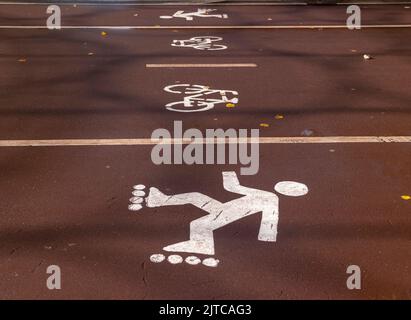 Dedicated bicycle lane with bicycle and roller skates sign, designed to make cycling. Stock Photo