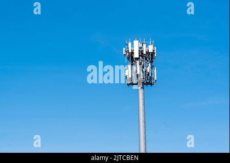 Cell Tower against blue sky with large side for text Stock Photo