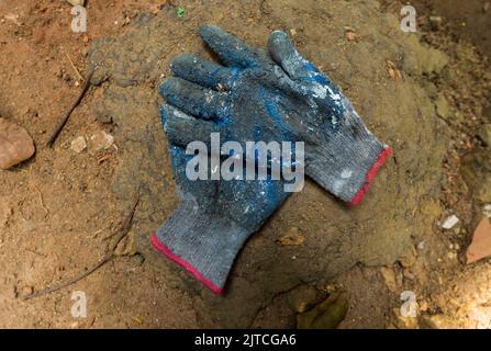 Construction worker, Gardner, painter, gloves worn out due to heavy work Stock Photo