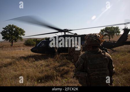 Soldiers assigned to Hardrock and Bulldog Company, 1st Battalion, 502nd Infantry Regiment, 2nd Brigade Combat Team, 101st Airborne Division (Air Assault), conduct Air Assault Operations in conjunction with a Support by Fire Live Fire Exercise on August 29, 2022, at Babadag Training Area, Romania. The Screaming Eagles of today are ready to support our allies in order to preserve the long-lasting stability in Europe that our predecessors fought and died for. (U.S. Army photos by Staff Sgt. Malcolm Cohens-Ashley, 2nd Brigade Combat Team, Public Affairs.) Stock Photo