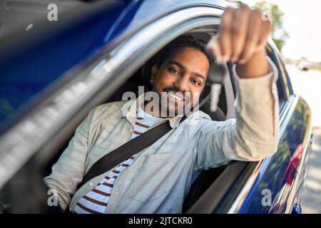 smiling indian man or driver showing car key Stock Photo