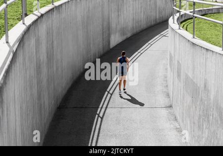 young man running in tunnel outdoors Stock Photo