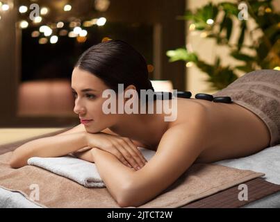 woman having hot stone massage at spa Stock Photo