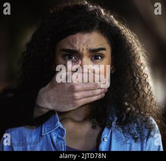 In a desperate situation. Portrait of a young woman being grabbed by a criminal in the city. Stock Photo