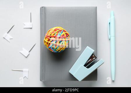 Set of stationery with colorful rubber band ball on white background Stock Photo
