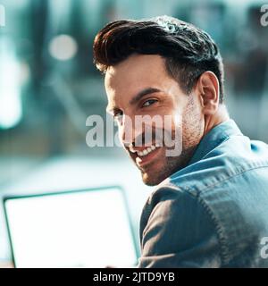 Ive set my sights on the entrepreneurial prize. Portrait of a confident young businessman using a laptop at his desk in a modern office. Stock Photo