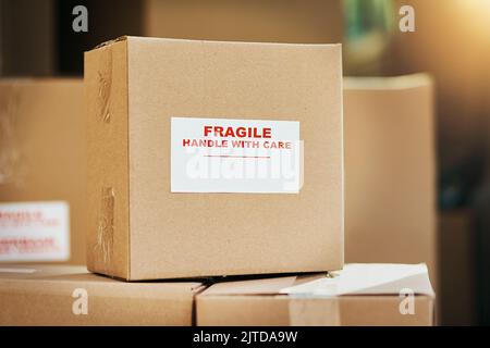 Fragile contents inside. Still life shot of cardboard boxes marked as fragile and ready for delivery. Stock Photo