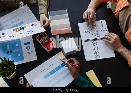 Top down view at table with documents and diverse team planning design project Stock Photo
