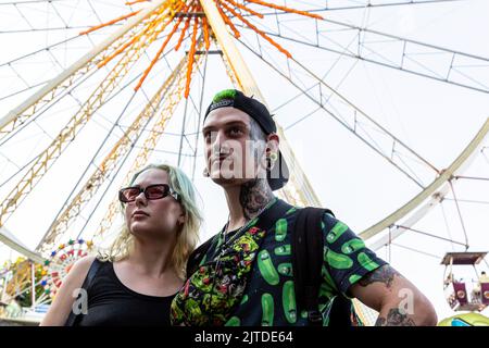 Odessa, Ukraine. 29th Aug, 2022. A couple attends an amusement park by the boulevard in a coastline park in a famous Black Sea resort of Odessa as the country surpassed 6 months after the Russian invasion. People try to live their normal lives in the city despite the regular sirens and the beach on the Black Sea coastline is largely closed to tourists as the area could contain mines or other explosives. Credit: SOPA Images Limited/Alamy Live News Stock Photo