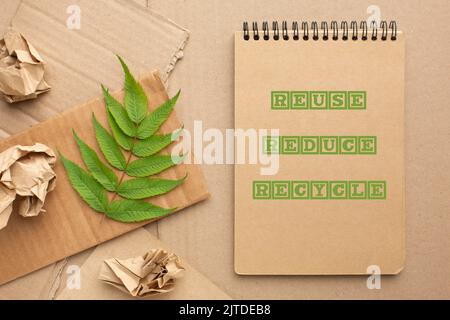 Reduce Reuse Recycle concept. Leaf and Paper strips with cut out text ...