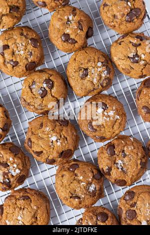 A tray of chocolate chip cookies topped with flakey sea salt. Stock Photo