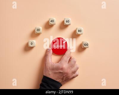 Hand turning volume control knob for maximum loudness. Stock Photo