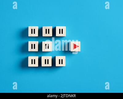 Play and pause icons on wooden cubes. Business startup, taking action and business acceleration and success concept. Stock Photo