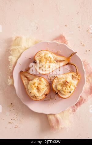 grilled pears baked with ricotta cheese and walnuts. honey topping Stock Photo