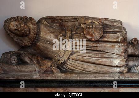 Elizabethan and Jacobean gentleman, John Wheately (died 1616), who gave money to help defeat the Spanish Armada, lies stiffly and uncomfortably on his tomb in the nave of the early-13th century Parish Church of St Nicolas at Pevensey, East Sussex, England, UK. Stock Photo