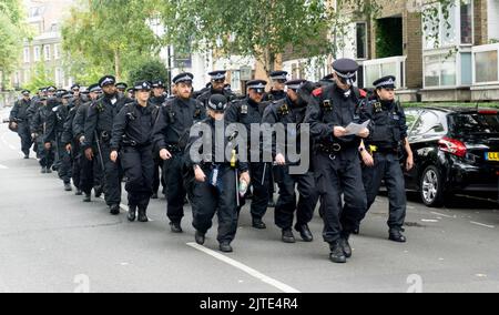 Londoners and tourists alike enjoy the last day of Notting Hill Carnival 2022 under strong police presence. Stock Photo