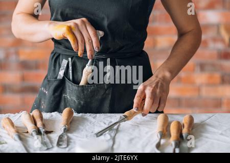 carving tools craft set woman apron chisel Stock Photo