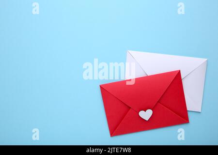 Red and white envelopes with heart on blue background Stock Photo