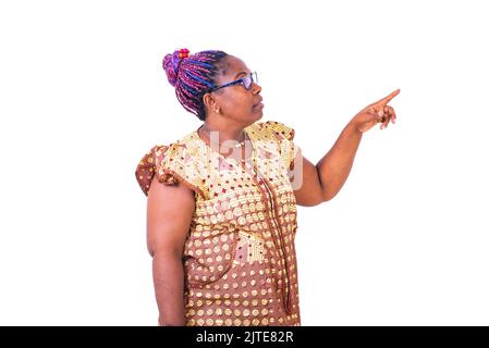 mature woman wearing glasses, standing and pointing finger aside. Stock Photo