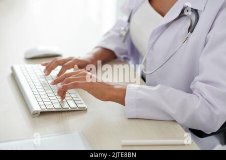 Hands of female doctor working on computer Stock Photo