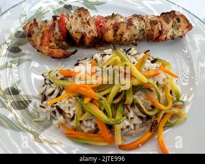 Grilled Greek souvlaki skewer with wild rice and vegetables Stock Photo